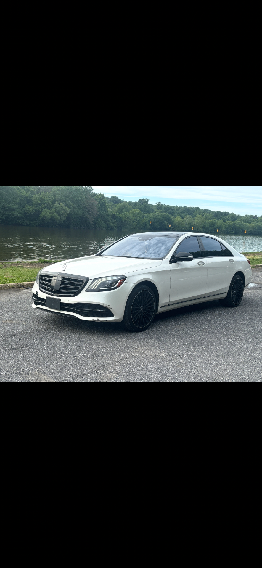 Pearl-white Mercedes-Benz S-Class at a riverside